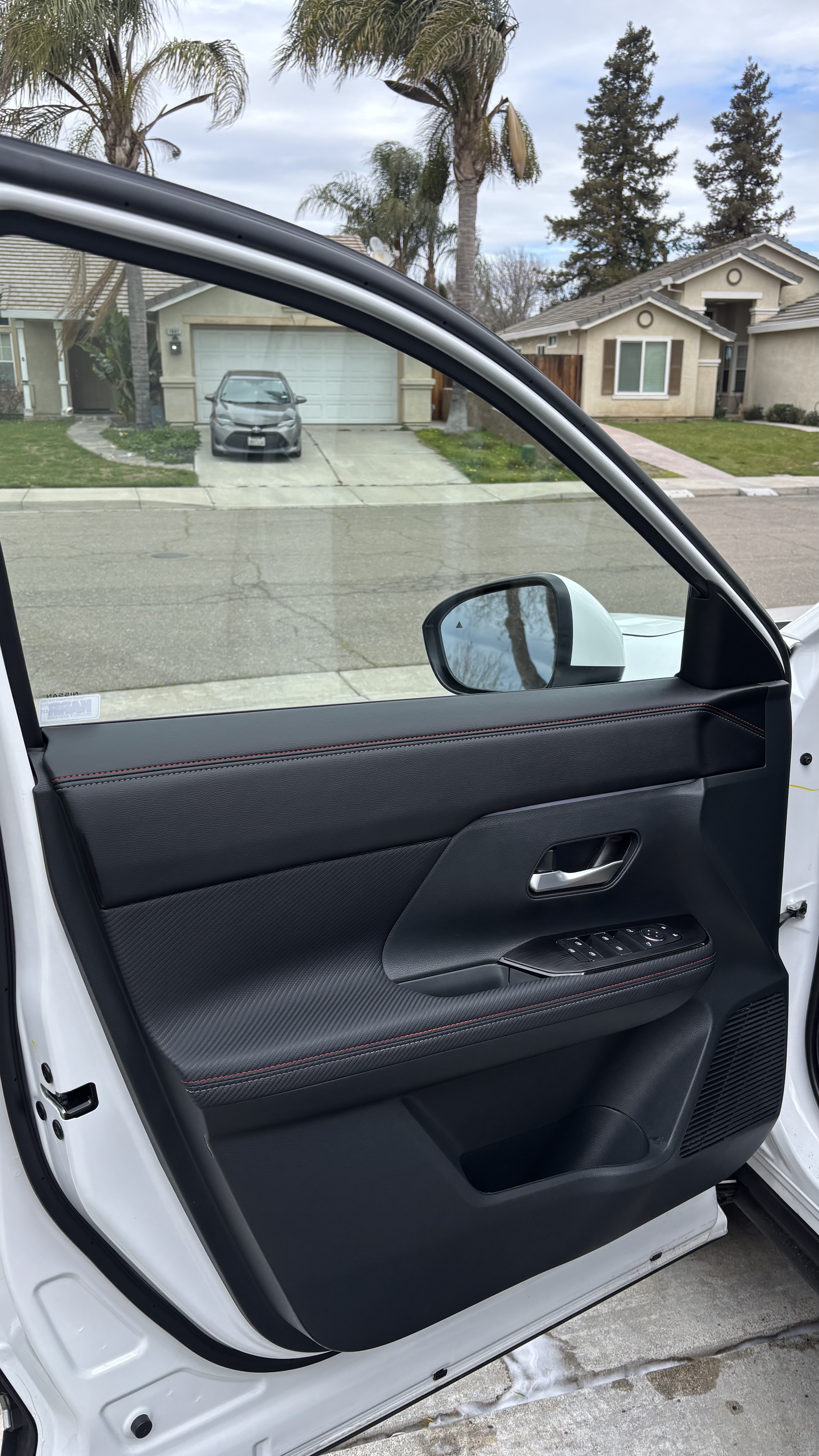 Kia door panel detail, spotless with red stitching accent